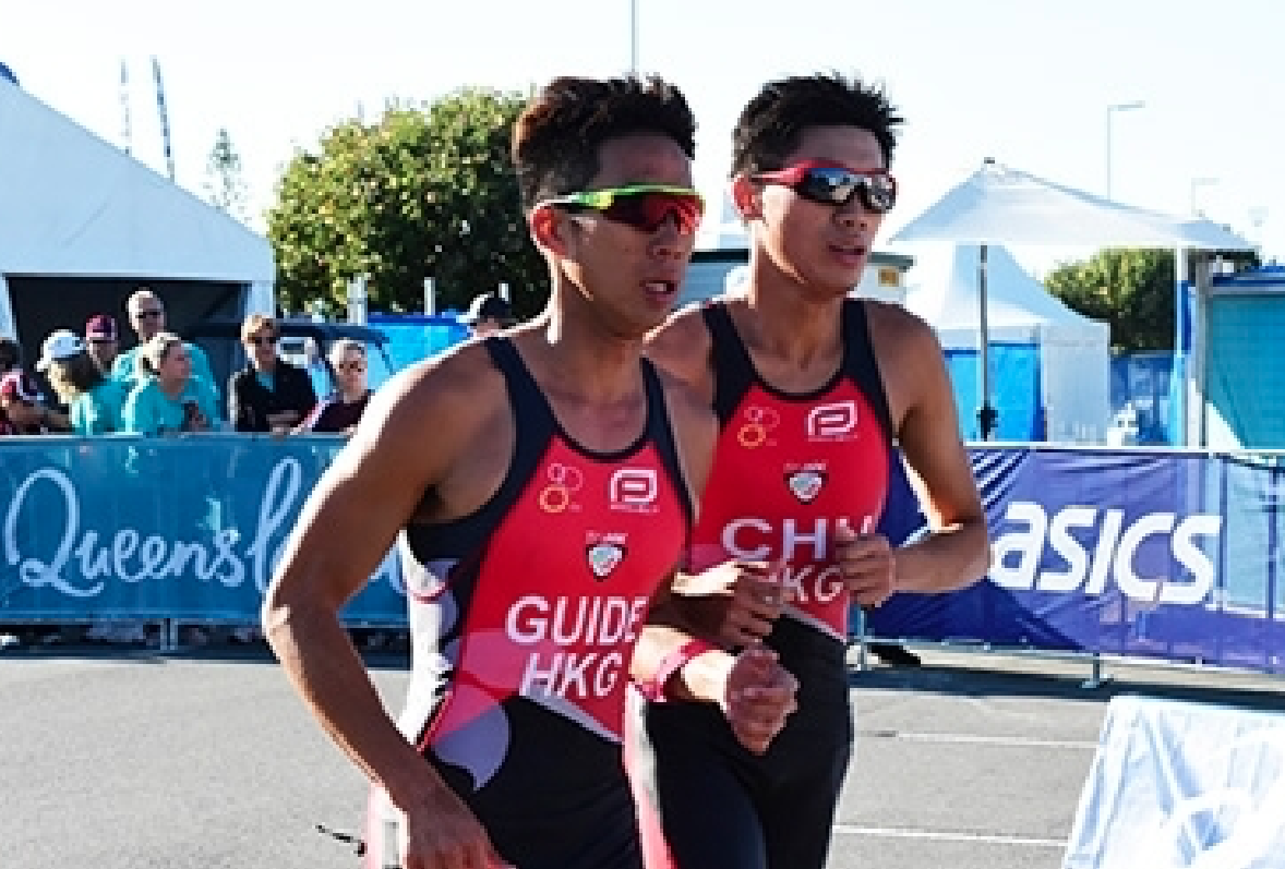 Two triathletes running side by side